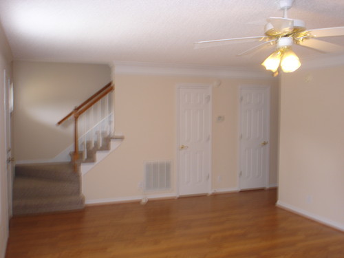 Living room looking back to main enterance and stairway, Half bath behind a door